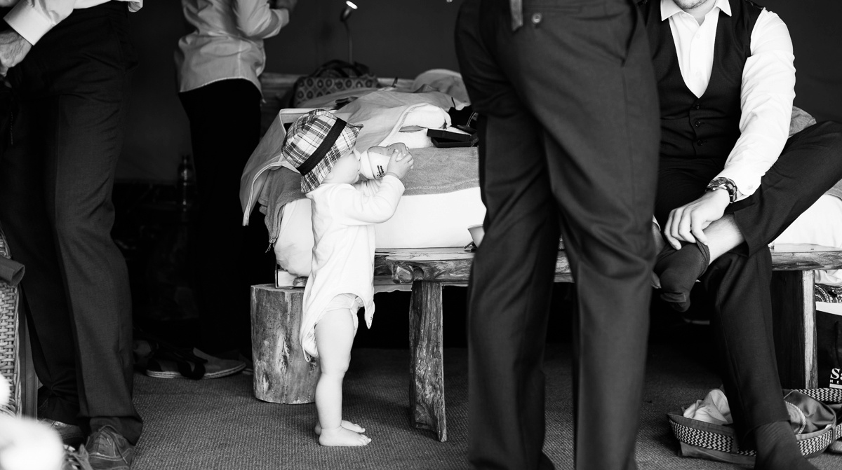 the groom is getting ready with all his groomsmaid while the baby is drinking his milk - wedding photographer in ireland